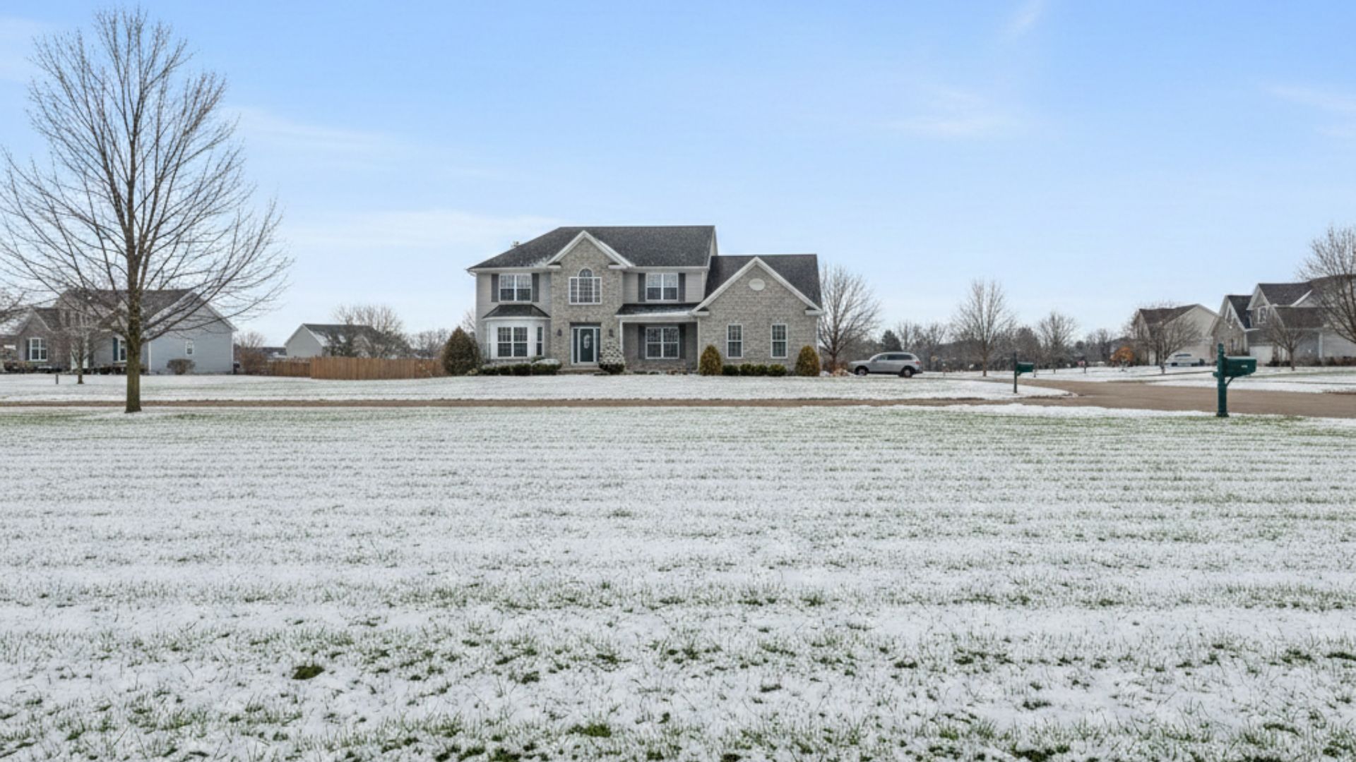 Snow-covered lawn showing early winter turf stress.